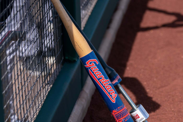 Mar 25, 2022; Scottsdale, Arizona, USA; A warm-up bat with the new branding for the Cleveland Guardians rests on the dugout fencing during spring training against the San Francisco Giants at Scottsdale Stadium. Mandatory Credit: Allan Henry-USA TODAY Sports